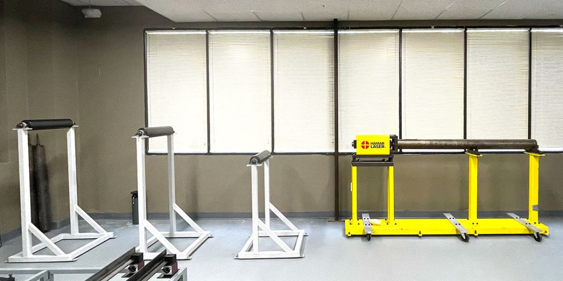 Roll alignment and extruder simulator rigs for hands-on laser alignment training at Hamar Laser's Brookfield facility.